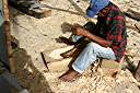 Carib craftsman from Dominica hand-hewing parts to repair damage to Gli Gli.