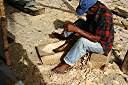 Carib craftsman from Dominica hand-hewing parts to repair damage to Gli Gli.