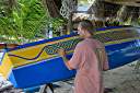 Aragorn painting "Malfini", an Arawak dugout sailing canoe.