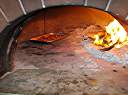 A pound of bacon cooking in Davide's pizza oven. Filet pignon.