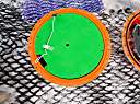 The inside of the new treasure. The top half contains the electronics bay. The black object on the edge of the green disk is an ocean temperature sensor.