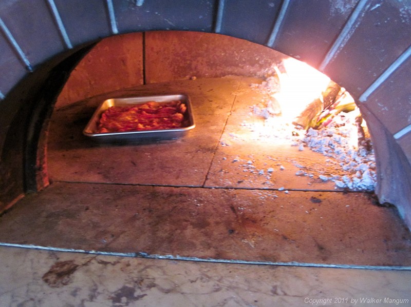 A pound of bacon cooking in Davide's pizza oven. Filet pignon.